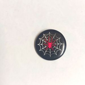 Small red and black spider web button
